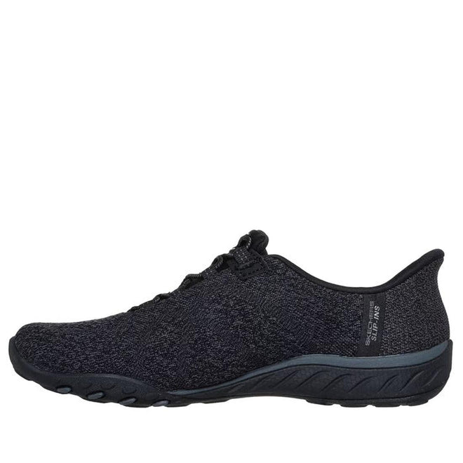 The Skechers Breathe Easy Knitty Waves SLIP IN Black is a slip-on athletic shoe with a textured fabric upper, low profile, black rubber sole, Stretch Fit, and Air-Cooled Memory Foam, shown in side view on a white background., 198376792176, 198376792190, 198376792213, 198376792237, 46778
