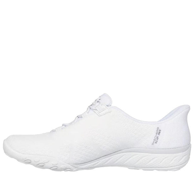 A side view of the Skechers Breathe Easy Knitty Waves SLIP IN in white, showcasing a textured sole, mesh upper, and slip-in design. Air-Cooled Memory Foam ensures comfort. Lightweight and breathable—perfect for sports or casual wear., 198739188073, 198739188097, 198739188110, 49282, 49283