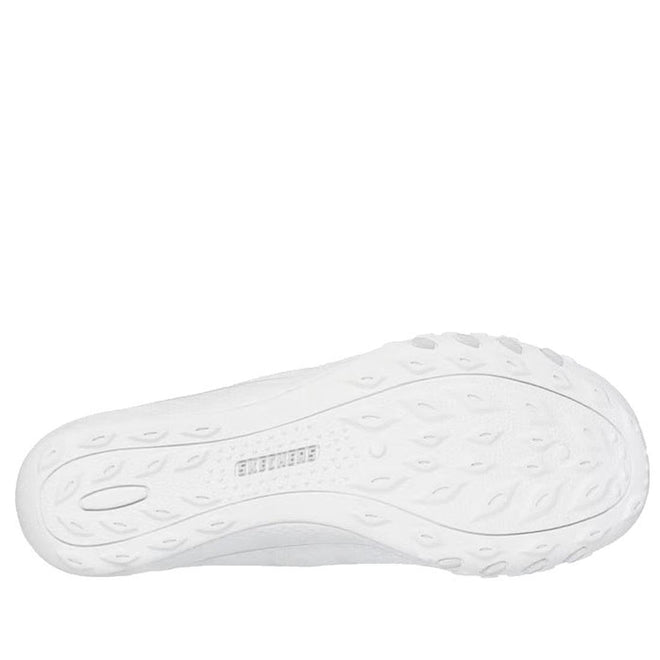 The image displays the bottom view of a Skechers Breathe Easy Knitty Waves SLIP IN white shoe, featuring a textured, wavy tread pattern and "SKECHERS" embossed at the center of the sole., 198739188073, 198739188097, 198739188110, 49282, 49283