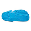The image shows the bottom view of the Crocs Kids - Toddlers Classic Clog K Paint Splatter Print Blue Pink Multi, highlighting its textured sole for grip and central crocs branding—perfect lightweight shoes for active toddlers., 47582, 198445214134, 198445214141, 198445214158, 198445214097