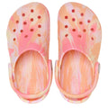 The Crocs Kids Toddlers Classic Clog K Marbled in Guava Pink Multi features a pink, peach, and white tie-dye pattern and is shown from above with heel straps outward., 49874, 198445341021, 198445341038, 198445341045, 198445340987