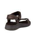 The Woden Line Women's 3 Strap Sandal in Chocolate Brown offers comfort with adjustable straps, a cushioned sole featuring Natural Soft technology, visible stitching, and a thick sole. Shown from a back angled side view., 48196, 5713326592511, 5713326592528, 5713326592535, 5713326592542, 5713326592559, 5713326592566