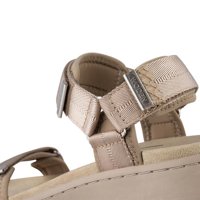 Close-up of the Woden Line Women's 3 Strap Sandal in Silver Mink, featuring beige cushioned comfort, adjustable nylon straps with a metal buckle, and a small metal tag engraved with the Woden brand name., 48203, 48204, 5713326605235, 5713326605242, 5713326605259, 5713326605266, 48209