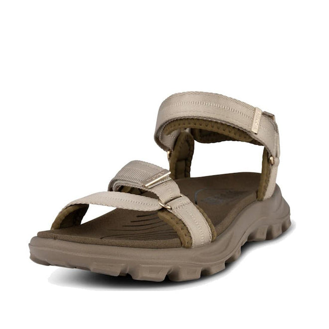The Woden Sandie Women's Chunky Sandal Stone features adjustable straps and a rugged, textured sole, crafted from durable materials for outdoor comfort.