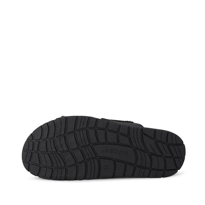 The Woden Lisa Women's Leather 2 Strap Sandal Black features a black rubber sole with wavy tread patterns, embossed "47" and "WODEN" at the center, an anatomically shaped footbed, displayed on a plain white background., 5713326518276, 5713326518283, 5713326518290, 5713326518306, 5713326518313, 3935713326518320, 5713326518269