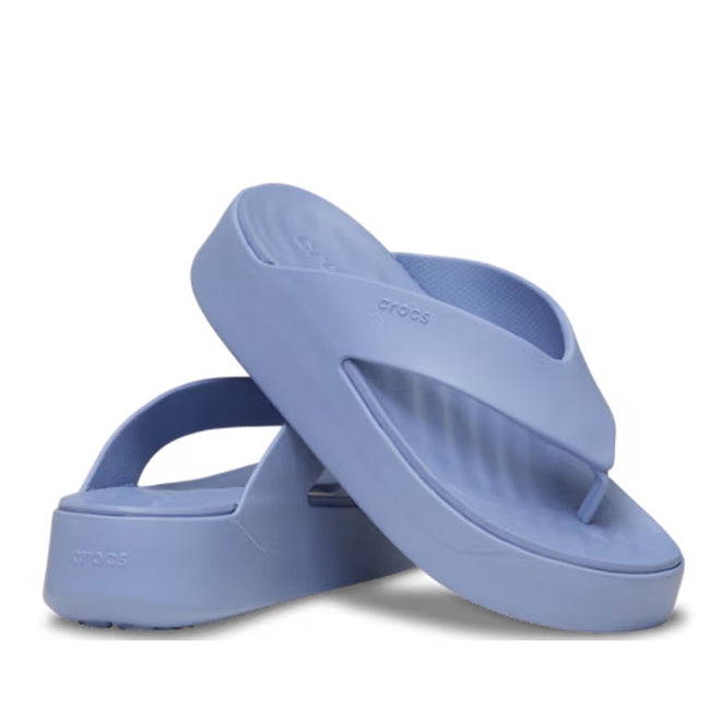 A pair of Crocs - Womens Getaway PLATFORM Flip Sandal Blue Haze from the Getaway Collection, featuring thick soles, Free Feel Technology, and a textured footbed—one sandal upright, the other leaning against it.