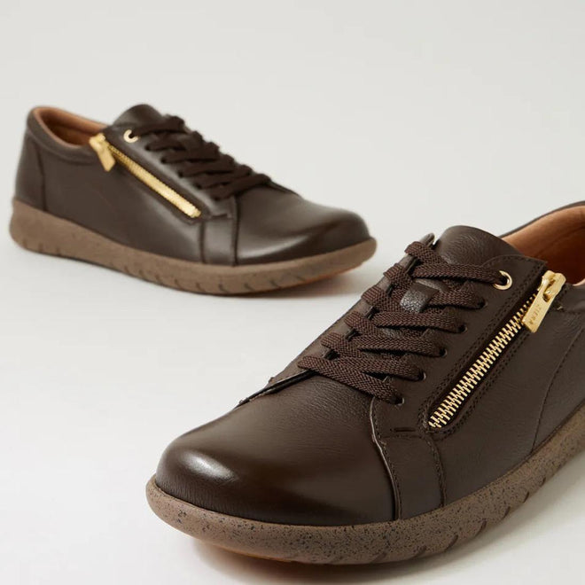 The Ziera Solar XW Women's Casual Sneaker features chocolate brown leather, brown laces, side gold zippers, and textured rubber soles, displayed against a plain light background., 51019, 44347555285581, 4434755525604, 4434755525628, 4434755525642, 4434755525666, 4434755525673