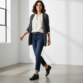 A woman with shoulder-length dark hair, wearing a white blouse, gray cardigan, blue jeans, and Ziera Sage XF Women's Wedge Heel Shoe in black leather, smiles as she walks in a bright modern room with large windows., 9355342543724, 9355342095629, 9355342095636, 9355342095643, 9355342095650, 9355342095667, 50983