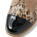 Close-up of the Ziera Tobin XF Women's Flat Brogue in Black Taupe Leopard: features a glossy black toe cap, leopard print leather, beige suede laces and panels, visible stitching on the brown rubber sole, and an extra wide fit for comfort., 51040, 4434755462978, 4434755462985, 4434755462992, 4434755463005, 4434755463012, 4434755463029