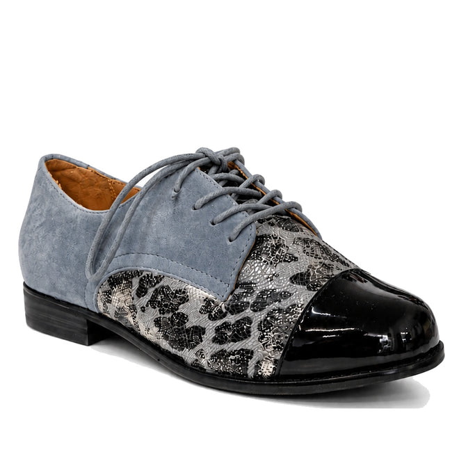 The Ziera Tobin XF Women's Flat Brogue in Black Slate Blue features a lace-up design with a light blue suede upper, black patent leather toe, silver and black snakeskin-patterned midsection, low black heel, and removable Comfort Plus footbed.