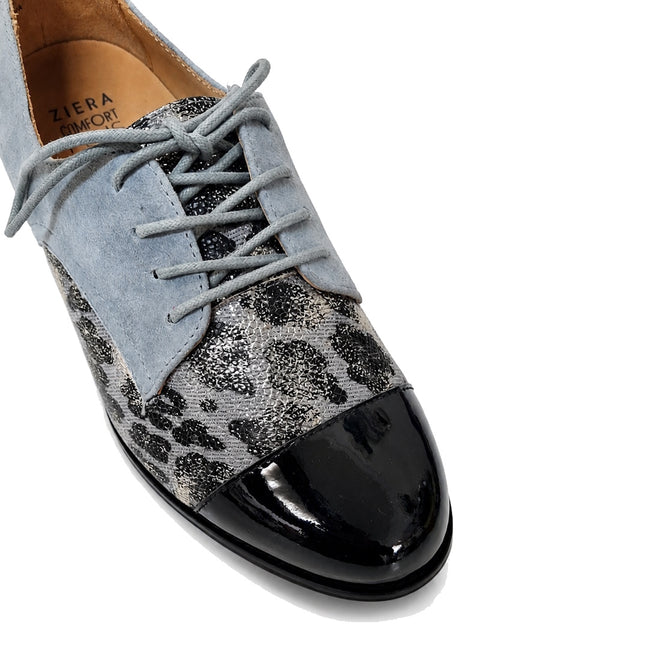 The Ziera Tobin XF Women's Flat Brogue in Black Slate Blue features leather with a silver and black animal print, light blue suede laces, a shiny black patent toe cap, tan insole labeled Ziera Comfort, and removable Comfort Plus footbed for extra wide fit., 4434755462862, 4434755462879, 4434755462886, 4434755462893, 4434755462909, 4434755462916, 51053
