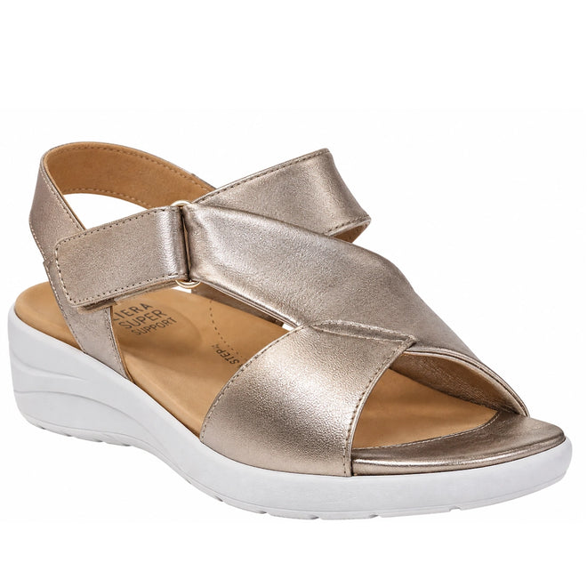 The Ziera Nazly2 Platino Gold White XW Women’s Leather Sandal features a metallic gold open-toe leather design with a thick white sole, an adjustable Velcro ankle strap, and a cushioned tan footbed that provides high arch support, shown against a white background.