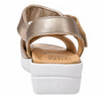 A close-up rear view of the Ziera Nazly2 Platino Gold White XW Women’s Leather Sandal, featuring a gold leather upper with an adjustable ankle strap and a thick white sole. The tan insole displays the Ziera Ultimate Comfort branding and is designed with high arch support and a removable footbed for customizable comfort.