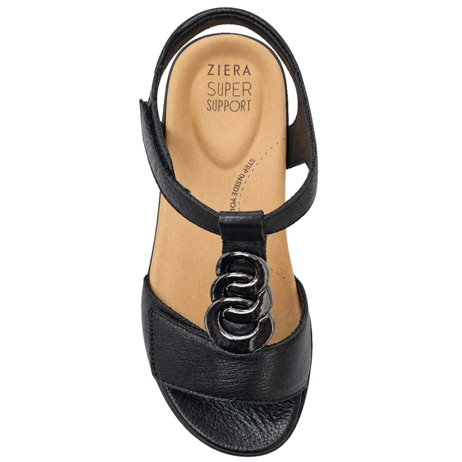 The Ziera Navvon Black XW Women’s Leather Slingback Sandal features a black open-toe design with a tan insole labeled Ziera Super Support. This sandal is adorned with a decorative metal chain on the front strap and includes a supportive heel strap, delivering excellent arch support for all-day comfort.