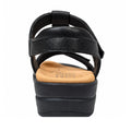 The Ziera Navvon Black XW Women’s Leather Slingback Sandal is shown from the back, featuring a thick black platform sole, a tan cushioned footbed with arch support, and a black leather ankle strap with visible stitching.