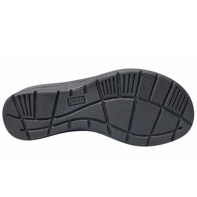 The Ziera Navvon Black XW Women’s Leather Slingback Sandal features a black rubber sole with textured tread patterns, including horizontal and vertical grooves, squares, and rectangles. The Ziera brand is embossed in the center of the sole. Engineered for comfort with excellent arch support, this sandal pairs perfectly with the casual leather wedge design and includes a removable super support footbed. The image background is plain white.