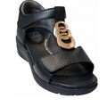 Ziera Nextime Black Leather Womens Sandal with Closed Back XW features a low wedge heel, open toe, and ankle strap. The upper strap is adorned with gold decorative rings, and the insole displays “Ziera Super Support” text. Designed in a wide fit for enhanced comfort, this sandal is orthotic compatible for personalized support.