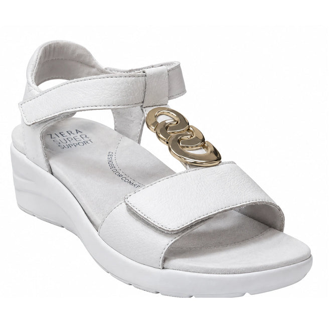 Introducing the Ziera Nextime White Womens Leather Sandal XW Closed Back: a stylish white sandal featuring a supportive wedge heel, adjustable straps, and a chic gold decorative chain on the upper strap. Designed for both comfort and style, it boasts a Ziera Super Support cushioned insole for all-day comfort, offers orthotic compatibility, and features a wide fit to ensure optimal support with every step.