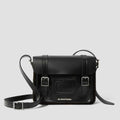 Image of right foot, side on of Dr Martens Leather Cross Body Black Leather Satchel 11 inch-Foot Forward Shoes
