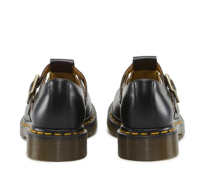 A picture showing the heel detailing and the over the foot strap of a pair of Dr Martens Polley Shoes T-Bar Mary Janes in Black leather., 883985498242,
883985498259,
883985498266,
883985498273,
883985498280,
883985498297,
883985498303,
883985498310,
