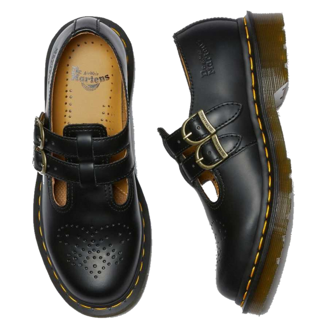 A pair of Dr Martens 8065 mary jane shes in balck . the right foot top down showing the partly punched detailing on the toe area and in yellow coloured insole. The left foot on it;s side showing the metal brass looking buckles  and the silloette of the sole. Both show the classic yellow stitching around the sole. 883985051775,
883985051782,
883985051799,
883985051805,
883985051812,
883985982772,
