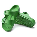 a pair of Birkenstock Kids EVA Fern Green Arizona Sandal Narrow Width with double straps, one over the foot and one over the toes with buckle adjustment. Staps are linked at the sides of the foot. Made of EVA a plastic like material, suitable fot being around water