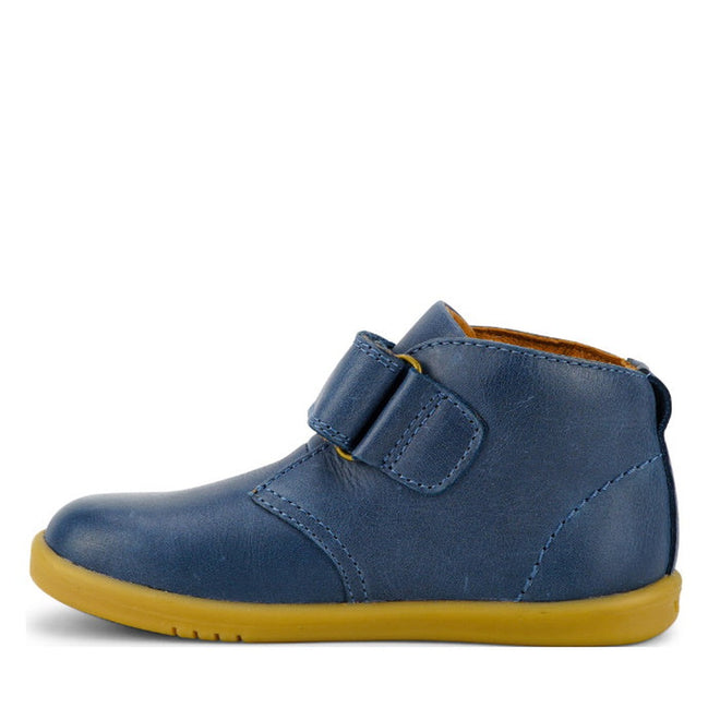 The Bobux Iwalk IW Desert Boot Midnight Blue 625217 is a single children’s boot in vintage blue leather with a yellow rubber sole and wide strap, shown side view facing left on a white background., 9420068516984, 9420068516991, 9420068517004, 9420068517011, 9420068517028