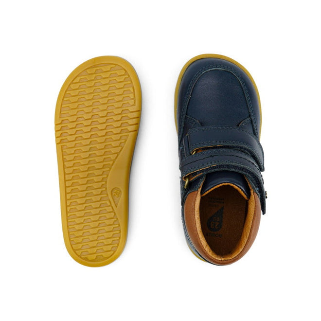 The Bobux Iwalk Timber Navy Leather Boot 632619 is a unisex children's shoe in navy blue leather with tan soles, shown from top and bottom views. Features include adjustable velcro straps and a comfortable tan interior lining., 9420068529298, 9420068529304, 9420068529311, 9420068529328, 9420068529335