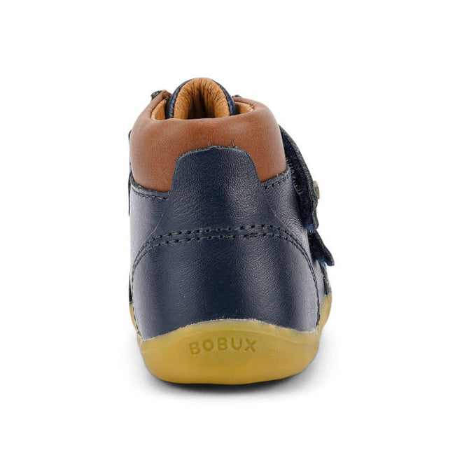 The Bobux Iwalk Timber Navy Leather Boot 632619 is a unisex toddler boot in navy and brown leather, featuring an adjustable strap, tan rubber sole, back view, and "BOBUX" branding on the heel., 9420068529298, 9420068529304, 9420068529311, 9420068529328, 9420068529335