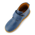 The Bobux Kid+ Desert Boot Midnight Blue 830312 is a unisex boot featuring a blue upper, brown sole, wide Velcro opening across the top, tan lining, and a rounded toe. Shown from above., 9420068517035, 9420068517042, 9420068517059, 9420068517066, 19835, 19836, 19837