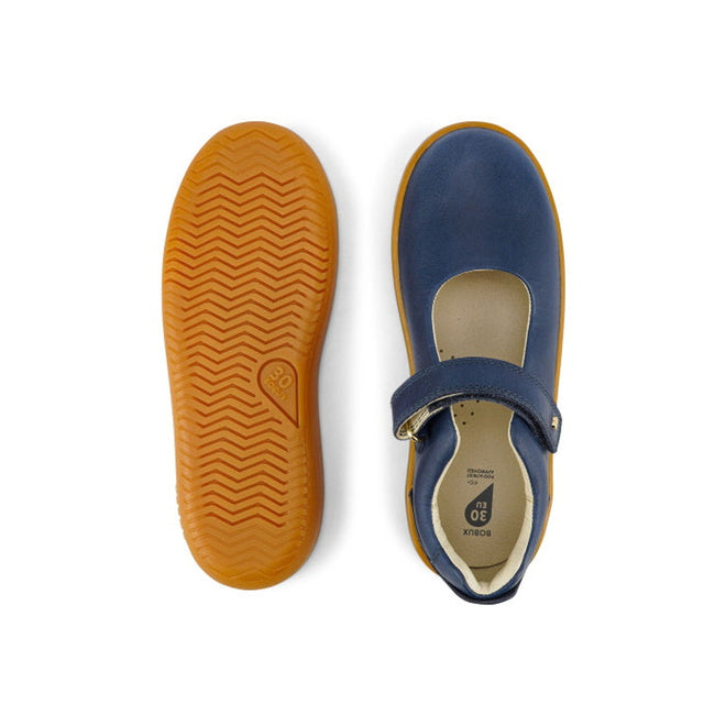 The Bobux Kid+ Delight Mary Jane Navy 831615Z features classic girls’ leather shoes with blue uppers, tan rubber soles, and a hook-and-loop strap. One shoe is shown from the top, the other from the bottom to display the tread pattern., 9420075721210, 9420075721227, 9420075721234, 9420075721241, 9420075721258, 9420068516847, 9420068516854