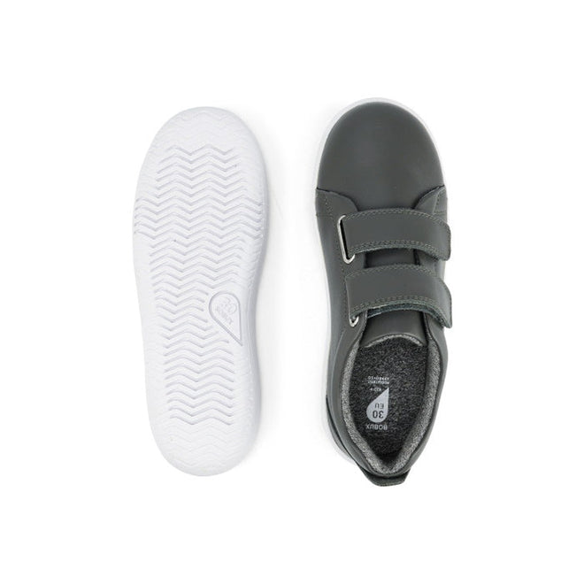 The Bobux Kids + Plus Grass Court Smoke Grey Velcro Trainers 832446 are dark gray kids’ shoes with white rubber soles, two velcro straps for easy fastening, and a textured sole for grip, shown from the top and bottom., 9420068518025, 9420068518032, 9420068518049, 9420068518056, 9420068518063, 9420068518070, 9420068518087