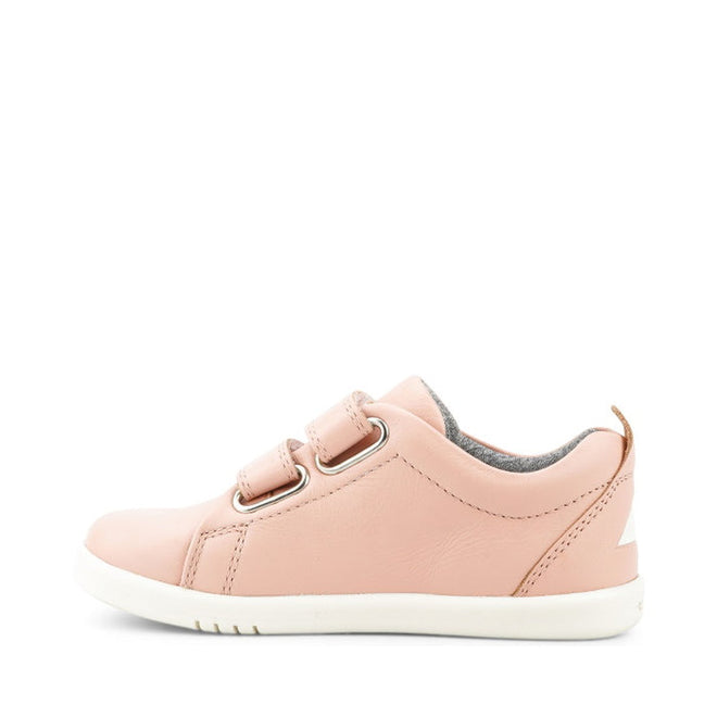 The Bobux KP Kid Plus Grass Court Seashell Pink 832448 is a light pink kids trainer with double velcro straps, white rubber sole, gray interior lining, and tan pull tab at the heel, shown in side profile on a white background., 9420075792579, 9420075793040, 9420075793125, 9420075794306, 9420075791602, 9420068517837, 9420068517844