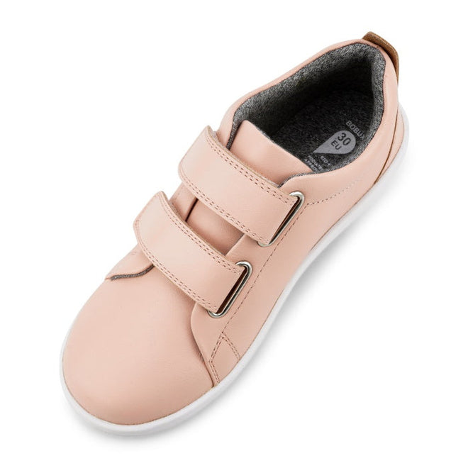 The Bobux KP Kid Plus Grass Court Seashell Pink 832448 is a light pink kids’ trainer with a leather upper, double velcro straps, white sole, and grey inner lining, shown from a top-down view., 9420075792579, 9420075793040, 9420075793125, 9420075794306, 9420075791602, 9420068517837, 9420068517844