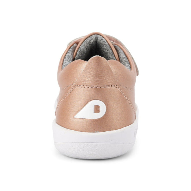 The Bobux Kids + Plus Grass Court Rose Gold Velcro Trainer 832455 features a smooth rose gold leather upper, a white sole, and a white B logo on the heel, with a gray inner lining for comfort., 9420071315741, 9420071315758, 9420071315765, 9420071315772, 9420071315789, 9420071315802, 9420071315796