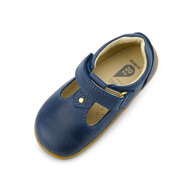 The Bobux Step Up T-Bar Louise Midnight Blue 728330 is a single toddler shoe with a blue leather upper, gold buckle, tan rubber sole, and EU size 20 insole, shown from above on a white background., 9420068521810, 9420068521827, 9420068521834