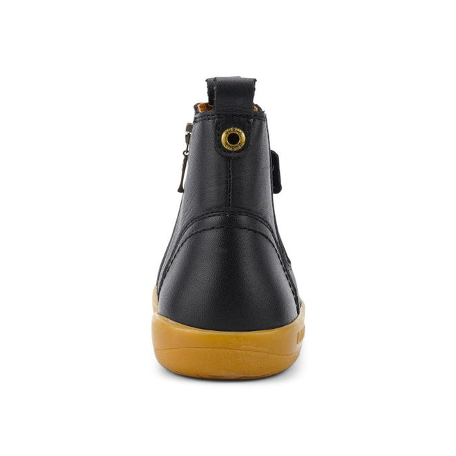 The Bobux Kid+ Jodphur Boot Black 830016Z is a black unisex leather boot with a tan rubber sole, side zip closure, heel pull tab, top eyelet, and is shown from the back against a plain white background., 9420075719811, 9420075719828, 9420075719835, 9420075719842, 9420075719859, 9420075719866, 9420075719873