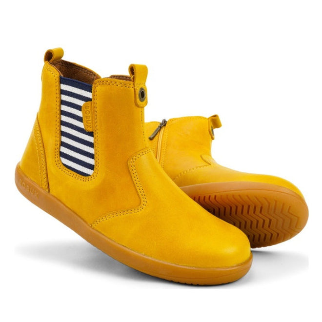 The Bobux Kid+ Jester Jodphur Boot in Chartreuse Yellow (830036 CLEARANCE) has side elastic panels with navy and white stripes, brown soles, pull tabs at both ends, and is shown upright and on its side.