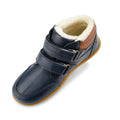 The Bobux Kid+ Timber Arctic WATERPROOF Boot Navy 836003E is shown from an angled top view, featuring two Velcro straps, a brown heel accent, rubber sole, and soft white fleece lining against a white background., 9420068529489, 9420068529496, 9420068529502, 9420068529519, 9420068529526, 9420068529533, 9420068529540