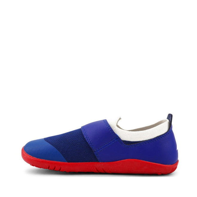 The Bobux Kid+ Lo Dimension III Blueberry 838605 CLEARANCE is a children’s slip-on shoe with a blue upper, white ankle trim, and bright red sole, combining merino comfort with the support of a flexible performance design., 9420068533134, 9420068533097, 9420068533080, 9420068533103, 9420068533110, 9420068533127, 9420068533141
