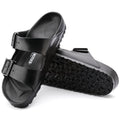 a pair of Birkenstock Arizona EVA Black REGULAR Width with double straps, one over the foot and one over the toes with buckle adjustment. Staps are linked at the sides of the foot. Made of EVA a plastic like material, suitable fot being around water