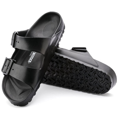 a pair of Birkenstock Arizona EVA Black REGULAR Width with double straps, one over the foot and one over the toes with buckle adjustment. Staps are linked at the sides of the foot. Made of EVA a plastic like material, suitable fot being around water