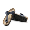 A pair of Birkenstock Gizeh Birko Flor Blue Regular Width sandals is shown, featuring blue straps, cork footbeds, and black textured rubber soles—one sandal upright and the other flat to reveal the sole.