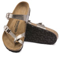 a pair of Birkenstock Mayari Metallic Graceful Taupe Regular Width- thin strappy sandals with bubkle adjustment over the foot and on the outside of the foot near the toe area. Straps cross cross over the toes and a separate strap over the top of the foot. Suede foot bed with arch support. Mostly a women's styel