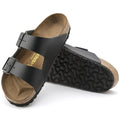 a pair of Birkenstock Arizona Smooth Leather Black Regular Width with double straps, one over the foot and one over the toes with buckle adjustment. Staps are linked at the sides of the foot. Leather thick straps and a suede leather footbed,