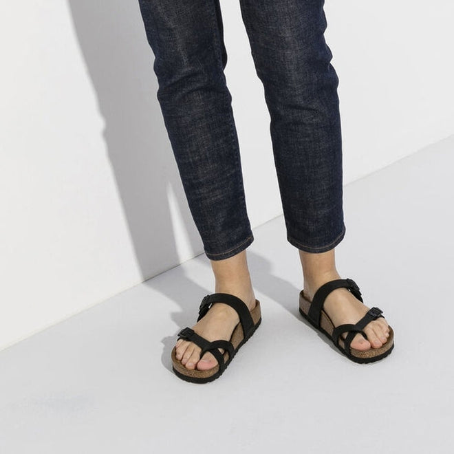 A persons legs and feet wearing 7/8 jeans and Birkenstock Mayari Sandals.,
4040714632186,4040714632155,4040714632162,4040714632179,4040714632193,4040714632209,4040714632216,4040714632223, , , , , 
