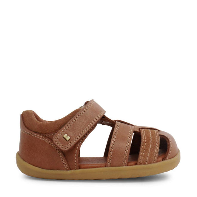 The Bobux Step Up Todders Sandal Roam 729204B in Caramel features a brown leather upper, closed heel, open toe, three front straps, and a hook-and-loop ankle strap—ideal first walking sandals—shown in profile on a white background., 15014, 9420062081464, 9420062081471, 9420062081488