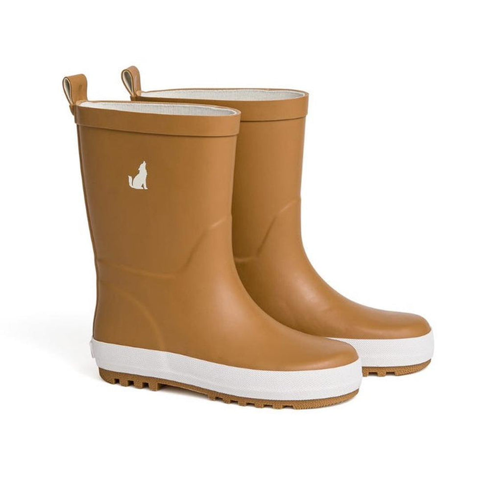 A pair of CryWolf Rain Boots Tan for children, featuring a brown color with white soles and a small white dog silhouette on the outer side of each boot. These waterproof boots are perfect for keeping little feet dry and stylish on rainy days.