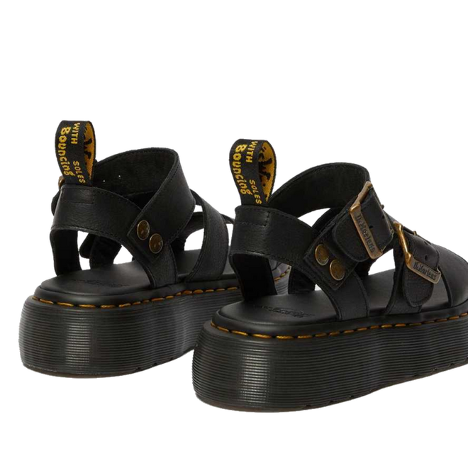 A rear shot of a pair of Dr Martens Gyrphon Sandals in Black shing teh dr martens branded pull tabs, yellow stitching around the sole and slightly platformed sole.,
190665318654,
190665318661,
190665318678,
190665318685,
190665318692,
190665318708,
190665318715,