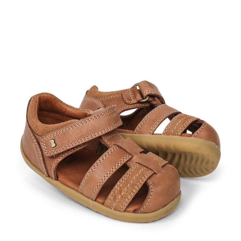 a pair of Bobux Step Up Todders Sandal Roam 729204B Caramel- closed toe sandals with closed back for heel support. velcro around the heel and straps of leather over the toes so air can move freely around the toes.